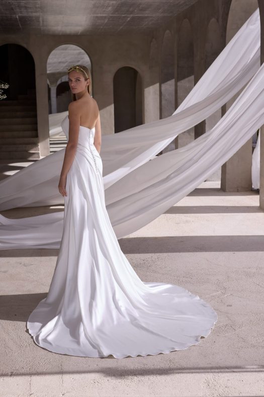 Morilee Zenobia Style 2941 is  a fit and flare, silky satin wedding dress with a strapless scoop neckline and a side slit.