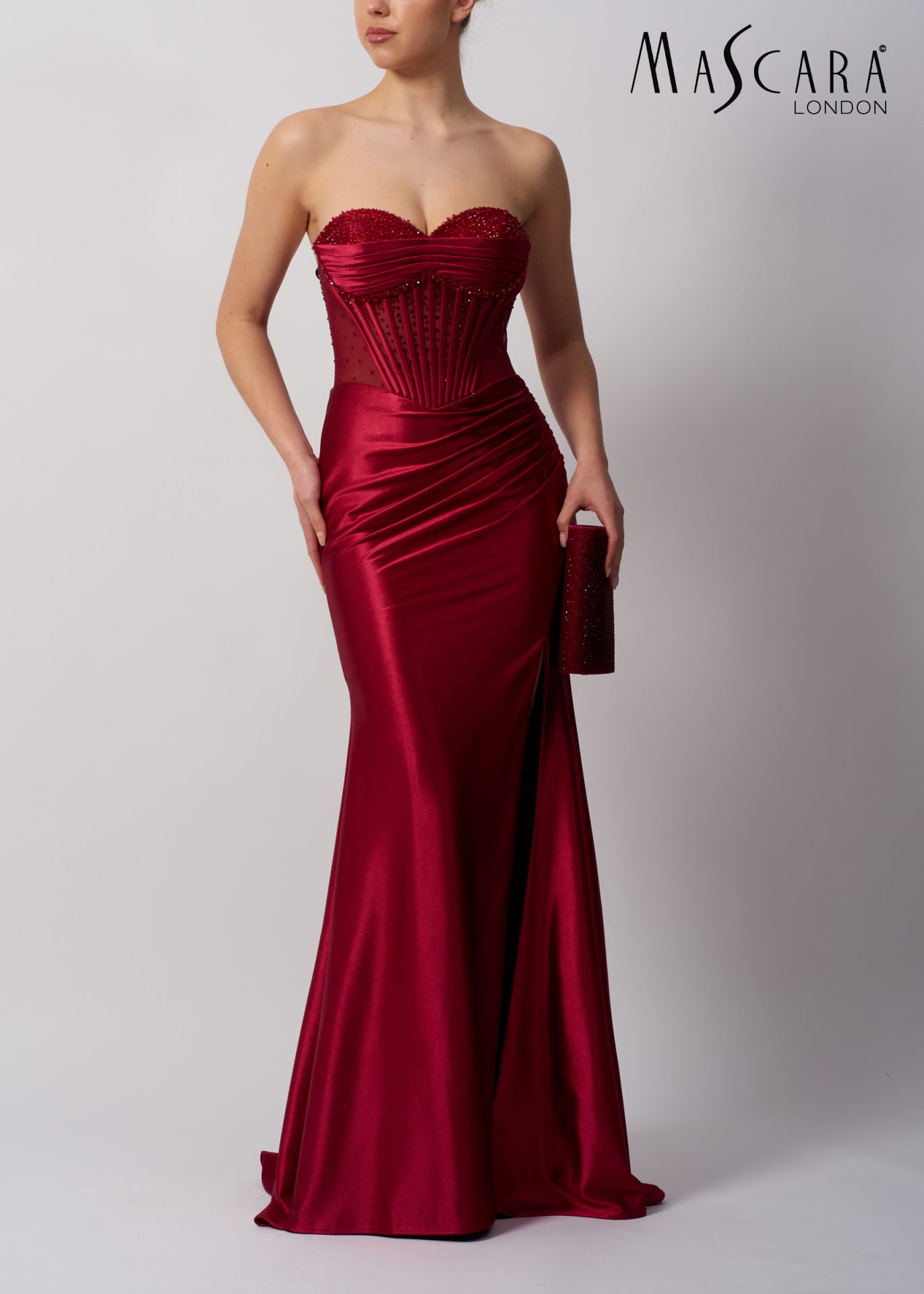 MC113423 Style MC113423 a fitted satin prom dress with beaded top and tie-up back. comes in many colours.