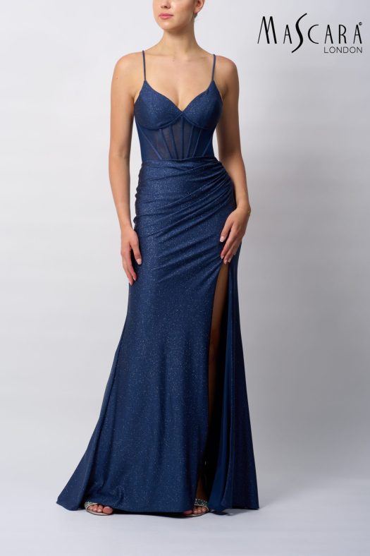 Style MC19427 a fitted glitter prom dress with a boned bodice, tie-up back and a skirt slit.