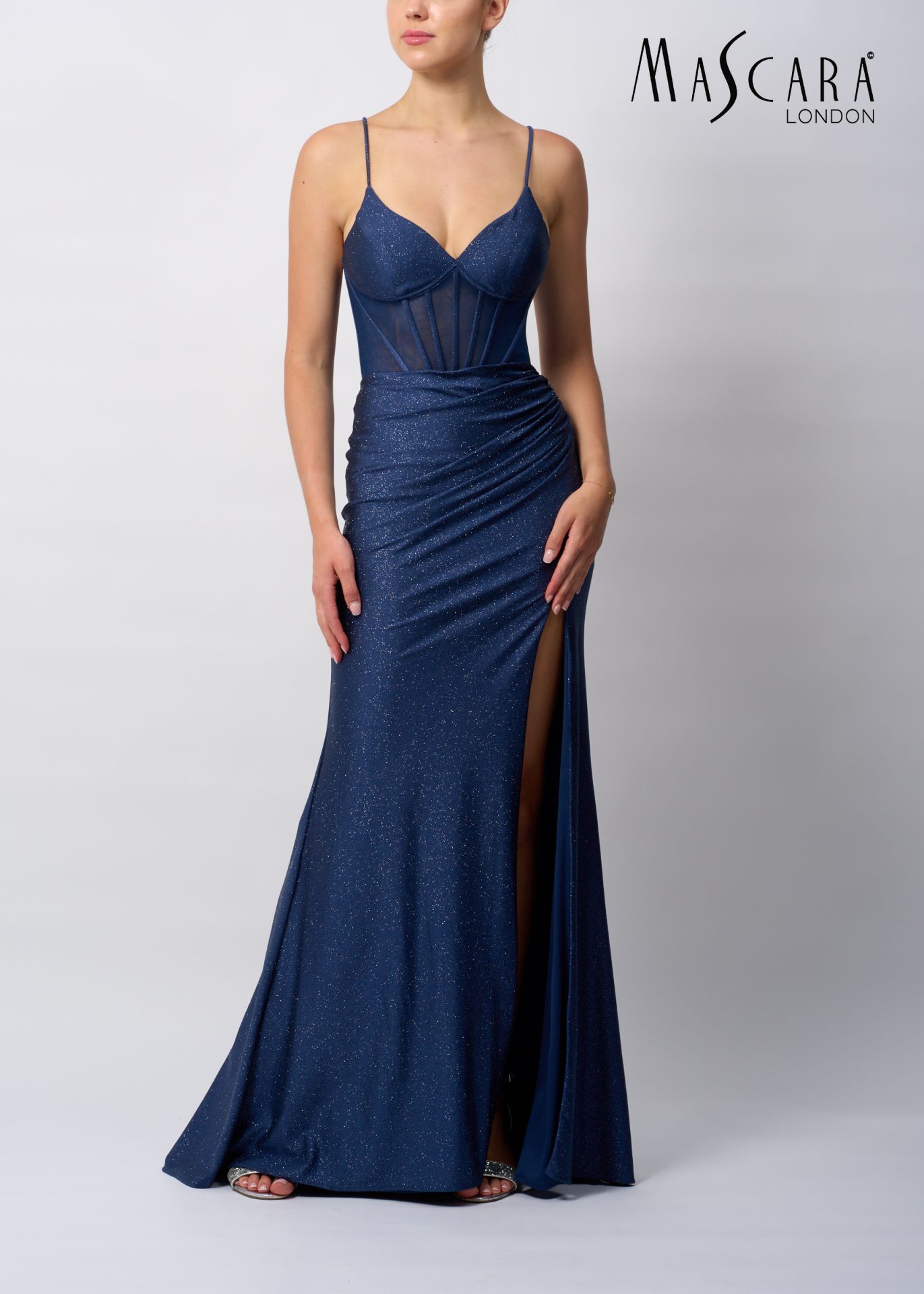MC19427 Style MC19427 a fitted glitter prom dress with a boned bodice, tie-up back and a skirt slit.