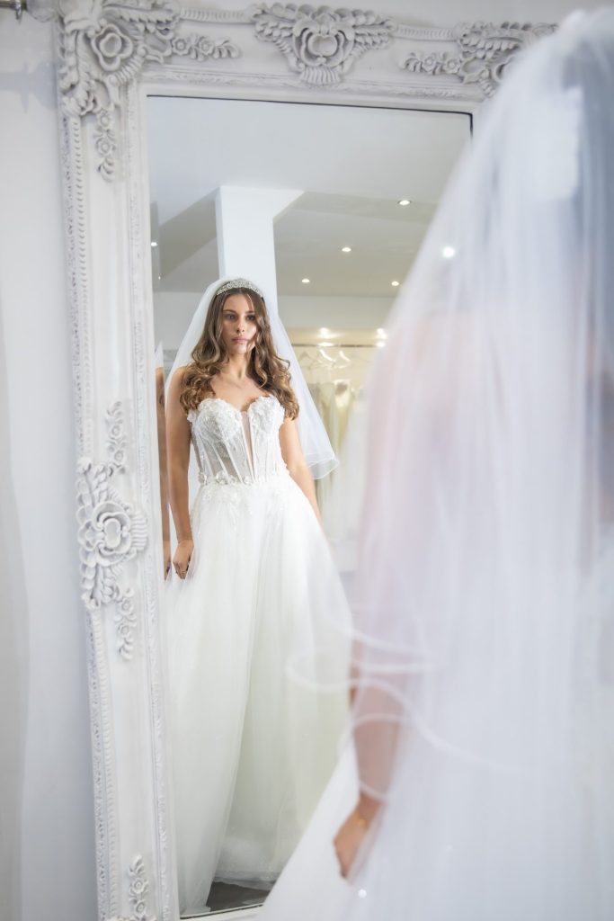 Bride looking the mirror at The Boutique uk