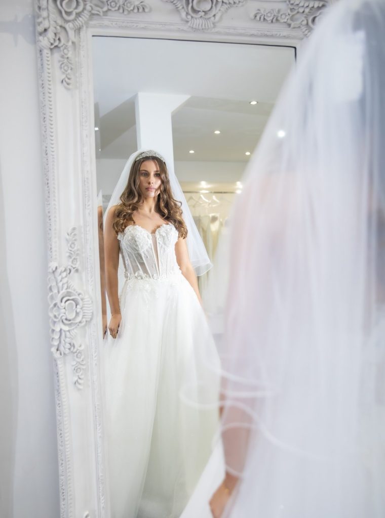 Bride looking the mirror at The Boutique uk