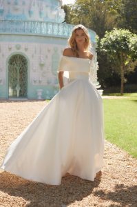 Alan Hannah wedding dress Naomi, a full skirted Mikado dress with off-the-shoulder collar. It has pockets and long train.