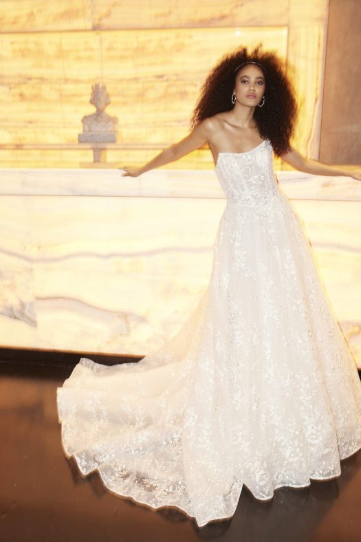 Larkin from the Miamia by Alan Hannah 2026 collection. A soft A-line wedding dress with a strapless bodice with layers of delicate floral lace.